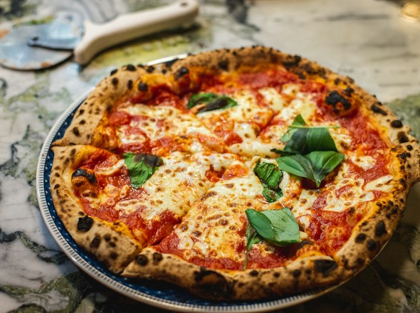 Pizza topped with fresh basil